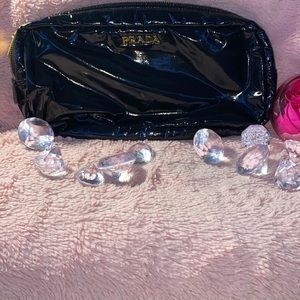 A black Prada makeup bag or hand bag